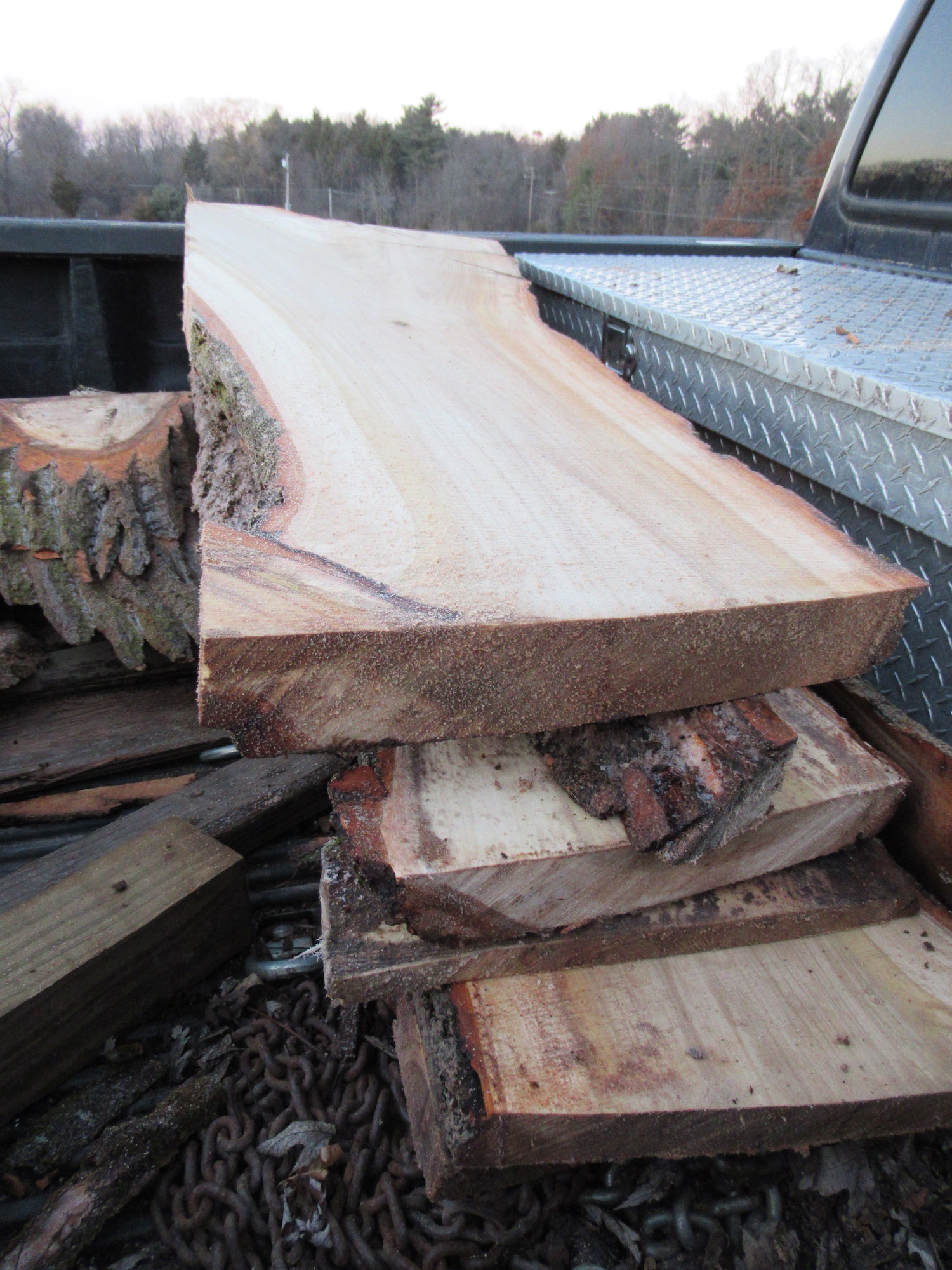 Live edge slabs stacked on a trailer