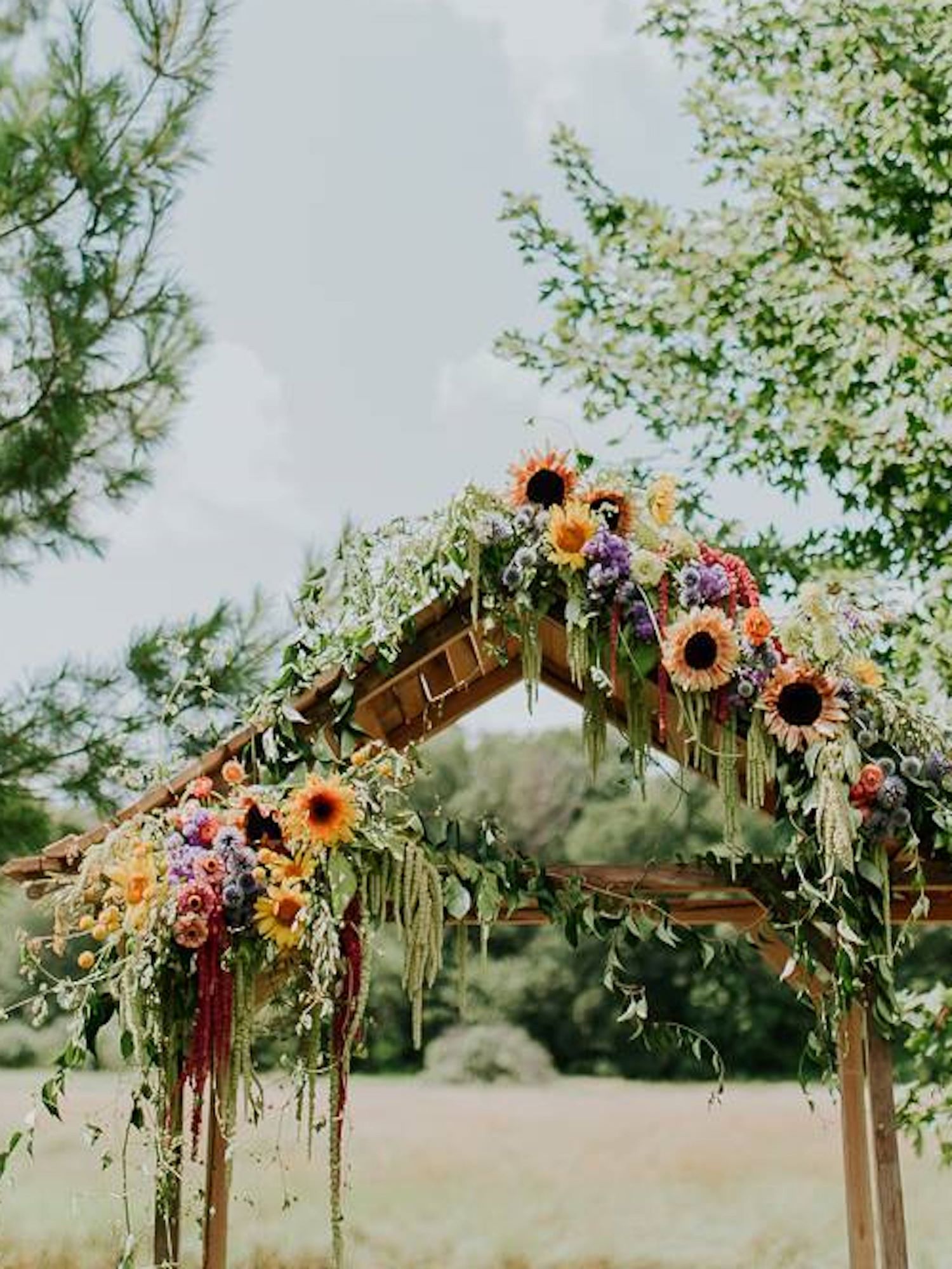 Front angle shot of wedding ceremony the arbor at a barn wedding